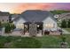A lovely backyard with a stone fireplace, wooden pergola, hot tub, and deck provides a tranquil outdoor space at 500 Chicory Cir, Matthews, NC 28104