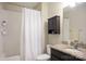 Bathroom with granite countertop vanity, shower with white curtain, and wall storage at 500 Chicory Cir, Matthews, NC 28104