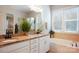 Well-lit bathroom features double sinks, granite countertops, a soaking tub and a separate shower at 500 Chicory Cir, Matthews, NC 28104