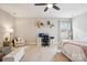 Spacious bedroom featuring a ceiling fan, desk area, seating area, and comfortable furnishings at 500 Chicory Cir, Matthews, NC 28104