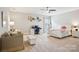 Spacious bedroom featuring a ceiling fan, desk area, seating area, and comfortable furnishings at 500 Chicory Cir, Matthews, NC 28104