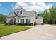 Attractive home featuring a well-maintained lawn, long driveway, black shutters, an American flag, and attached garage at 500 Chicory Cir, Matthews, NC 28104