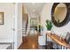 Welcoming foyer with hardwood floors, a staircase, stylish decor, and a view into the light-filled living area at 500 Chicory Cir, Matthews, NC 28104