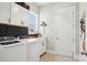 A well-lit laundry room offers white cabinets and modern appliances at 500 Chicory Cir, Matthews, NC 28104