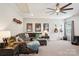 Living room with guitars, a comfortable sectional sofa and an expansive ceiling fan at 500 Chicory Cir, Matthews, NC 28104