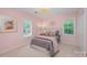 A charming bedroom with neutral colors, a queen bed, and bright light from shuttered windows at 5206 Morrowick Rd, Charlotte, NC 28226
