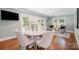 Breakfast area features a round table, modern chairs, hardwood floors, and lots of sunlight at 5206 Morrowick Rd, Charlotte, NC 28226
