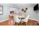Sunlit breakfast area displays a round table, modern chairs, and open concept design at 5206 Morrowick Rd, Charlotte, NC 28226
