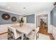 Bright dining room featuring modern lighting, neutral walls, wainscoting, and an open doorway at 5206 Morrowick Rd, Charlotte, NC 28226