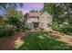 Traditional home boasts manicured lawn, mature trees, neutral paint, shutters, and covered entryway at 5206 Morrowick Rd, Charlotte, NC 28226