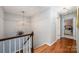 Hallway landing with traditional wood railing leads to upstairs bedrooms at 5206 Morrowick Rd, Charlotte, NC 28226