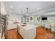 Eat-in kitchen features an island, pendant lighting, a stainless refrigerator, and hardwood floors at 5206 Morrowick Rd, Charlotte, NC 28226