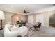 A spacious room with a large comfortable sofa, ceiling fan, carpet, and natural light at 5206 Morrowick Rd, Charlotte, NC 28226