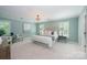 Bright main bedroom featuring large windows, neutral decor, and a comfortable king-size bed at 5206 Morrowick Rd, Charlotte, NC 28226