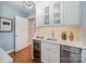The elegant wet bar features white cabinets, a beverage fridge, and a stylish backsplash at 5206 Morrowick Rd, Charlotte, NC 28226