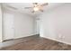 Bright bedroom featuring modern flooring, neutral paint, a ceiling fan, and closet access at 5310 Waverly Lynn Ln, Charlotte, NC 28269