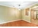 Empty dining room featuring wood floors, neutral walls, crown molding and hanging light fixture at 5310 Waverly Lynn Ln, Charlotte, NC 28269