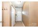 Hallway featuring neutral walls, coat hooks, storage closet and a white front door at 5310 Waverly Lynn Ln, Charlotte, NC 28269