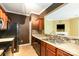 Modern kitchen with stainless appliances, tile backsplash, dark cabinets and a pass through to living room at 5310 Waverly Lynn Ln, Charlotte, NC 28269