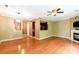 Spacious living room with wood floors, a ceiling fan, and a cozy fireplace at 5310 Waverly Lynn Ln, Charlotte, NC 28269