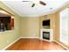 Spacious living room featuring a fireplace, ceiling fan, wood floors and pass through to kitchen at 5310 Waverly Lynn Ln, Charlotte, NC 28269