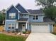 Charming two-story home with blue siding, black roof, a two-car garage and a well-maintained front lawn at 5733 Selkirk Dr, Hickory, NC 28601