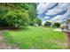 This backyard has grass, trees, and a storage shed at 605 Summey Farm Dr, Dallas, NC 28034