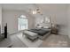 Cozy bedroom featuring vaulted ceiling, neutral decor, and ample natural light for relaxation at 605 Summey Farm Dr, Dallas, NC 28034