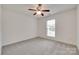This bedroom features neutral walls, a window, and a ceiling fan at 605 Summey Farm Dr, Dallas, NC 28034