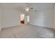 A bedroom featuring a ceiling fan, plush carpet, and open doorway to the primary bathroom at 605 Summey Farm Dr, Dallas, NC 28034