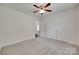 Bedroom featuring neutral carpet, ceiling fan, and closet doors at 605 Summey Farm Dr, Dallas, NC 28034