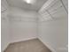 Walk-in closet with carpeted floor, white walls and wire shelving for optimal storage at 605 Summey Farm Dr, Dallas, NC 28034