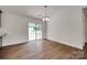 Dining area featuring hardwood floors, modern light fixture, and sliding glass doors to backyard at 605 Summey Farm Dr, Dallas, NC 28034