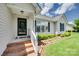 Inviting front porch with brick steps, decorative railing, and manicured greenery enhancing curb appeal at 605 Summey Farm Dr, Dallas, NC 28034