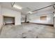 Spacious garage with concrete flooring, bright lighting, and ample room for storage and parking at 605 Summey Farm Dr, Dallas, NC 28034