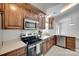 Well-lit kitchen with wooden cabinets, stainless steel appliances, and updated countertops at 605 Summey Farm Dr, Dallas, NC 28034
