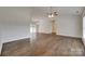 Spacious living room with vaulted ceilings, fan, and hardwood floors seamlessly connecting to dining area at 605 Summey Farm Dr, Dallas, NC 28034