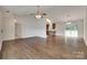 Open-concept living room with hardwood floors, a ceiling fan, and seamless flow to adjacent areas at 605 Summey Farm Dr, Dallas, NC 28034