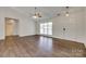 Bright living room featuring hardwood floors, a ceiling fan, and natural light from the large windows at 605 Summey Farm Dr, Dallas, NC 28034