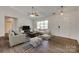 Bright living room with dark wood floors, a ceiling fan and natural light from the window at 605 Summey Farm Dr, Dallas, NC 28034