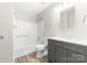 Bathroom featuring modern fixtures, a shower and bathtub combo, a gray vanity, and wood-look floors at 616 Silversmith Ln, Charlotte, NC 28270