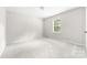 Bright bedroom with neutral walls and carpet, and a window for natural light at 616 Silversmith Ln, Charlotte, NC 28270