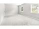 Bright, neutral-colored bedroom with carpet and a window at 616 Silversmith Ln, Charlotte, NC 28270