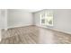 Bright bedroom with wood floors and a window for natural light at 616 Silversmith Ln, Charlotte, NC 28270