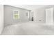 Spacious bedroom featuring two windows, neutral walls, and carpet at 616 Silversmith Ln, Charlotte, NC 28270