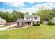 Charming two-story home with brick and vinyl siding, a well-manicured lawn, and mature trees at 616 Silversmith Ln, Charlotte, NC 28270
