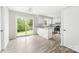 Modern kitchen with white cabinets, granite countertops, stainless steel appliances, and a sliding glass door at 616 Silversmith Ln, Charlotte, NC 28270