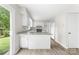 Bright and airy kitchen with white cabinetry, granite counters, and modern flooring, offering ample space at 616 Silversmith Ln, Charlotte, NC 28270