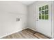 Functional laundry room with a white door leading to the backyard, and a wire shelf at 616 Silversmith Ln, Charlotte, NC 28270