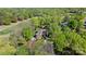 Aerial view of the luxury home surrounded by lush greenery, mature trees, and a golf course at 6202 Providence Country Club Dr, Charlotte, NC 28277